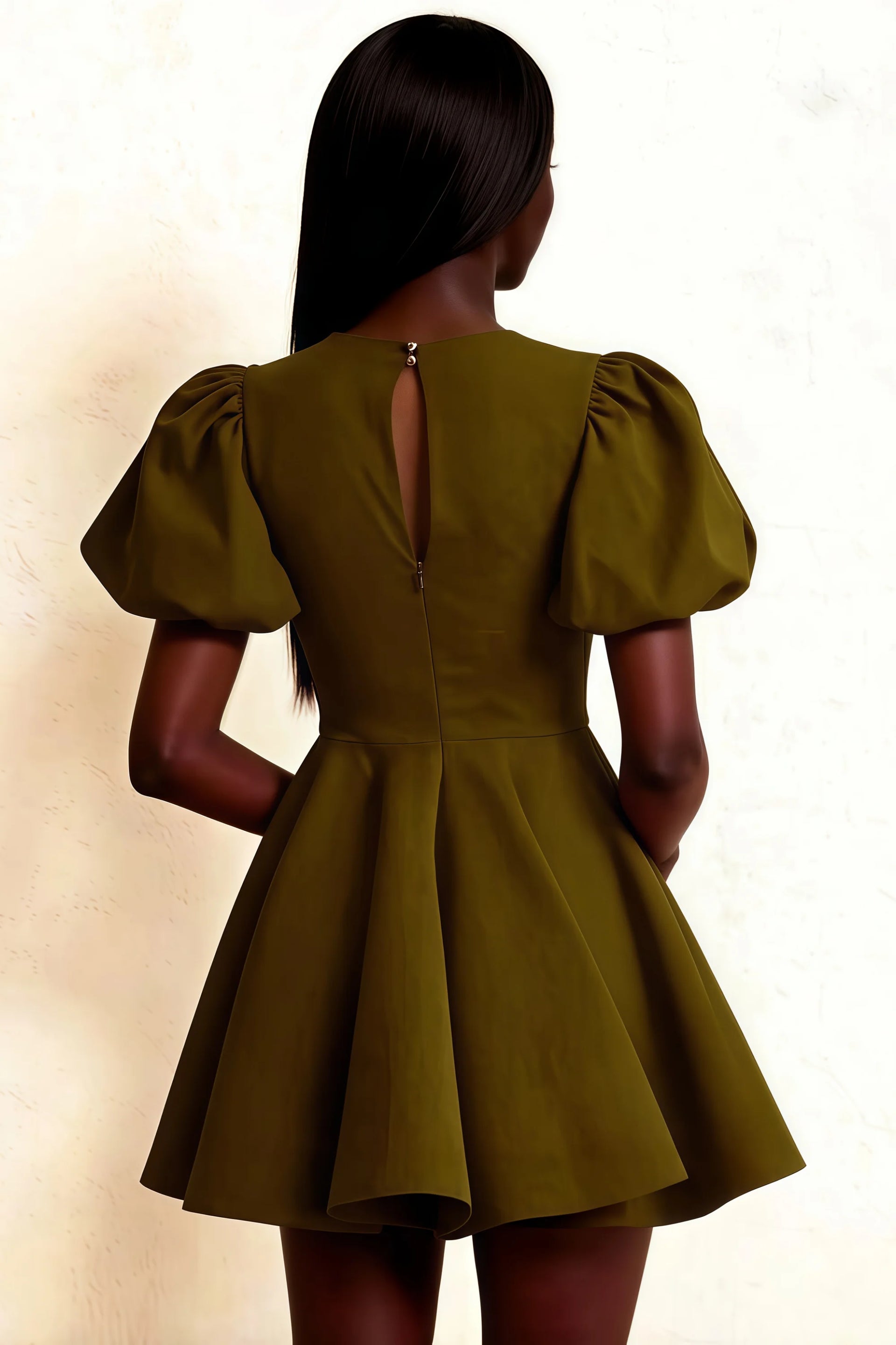 Elegant keyhole cutout at back of olive Celia dress, draped puff sleeves design, flowy A-line hem on model standing.