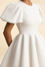 Close up of LVLVS Celia white stretch crepe fabric, crew neck puff sleeve mini dress detail, smooth texture and elegant gather sleeves