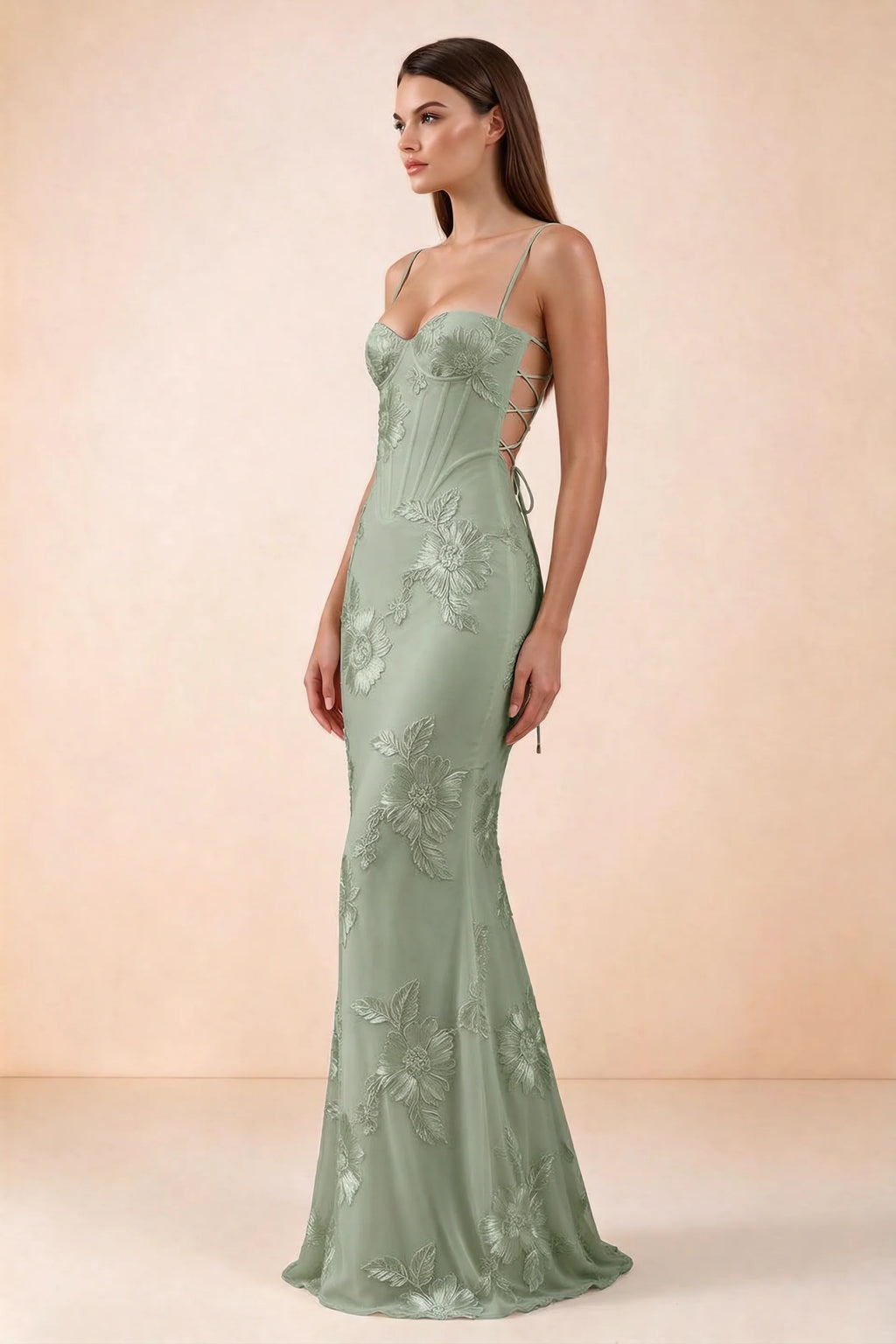 Side studio view of Celine sage green floral embroidered corset mermaid maxi dress with a long flared hem