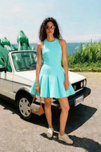 Customer wearing Cheryl aqua crepe skater mini dress casual outdoor styling with white sneakers