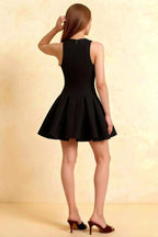 Cheryl black sleeveless skater dress back view, crepe material with concealed zipper, elegant high neck semi-formal mini dress