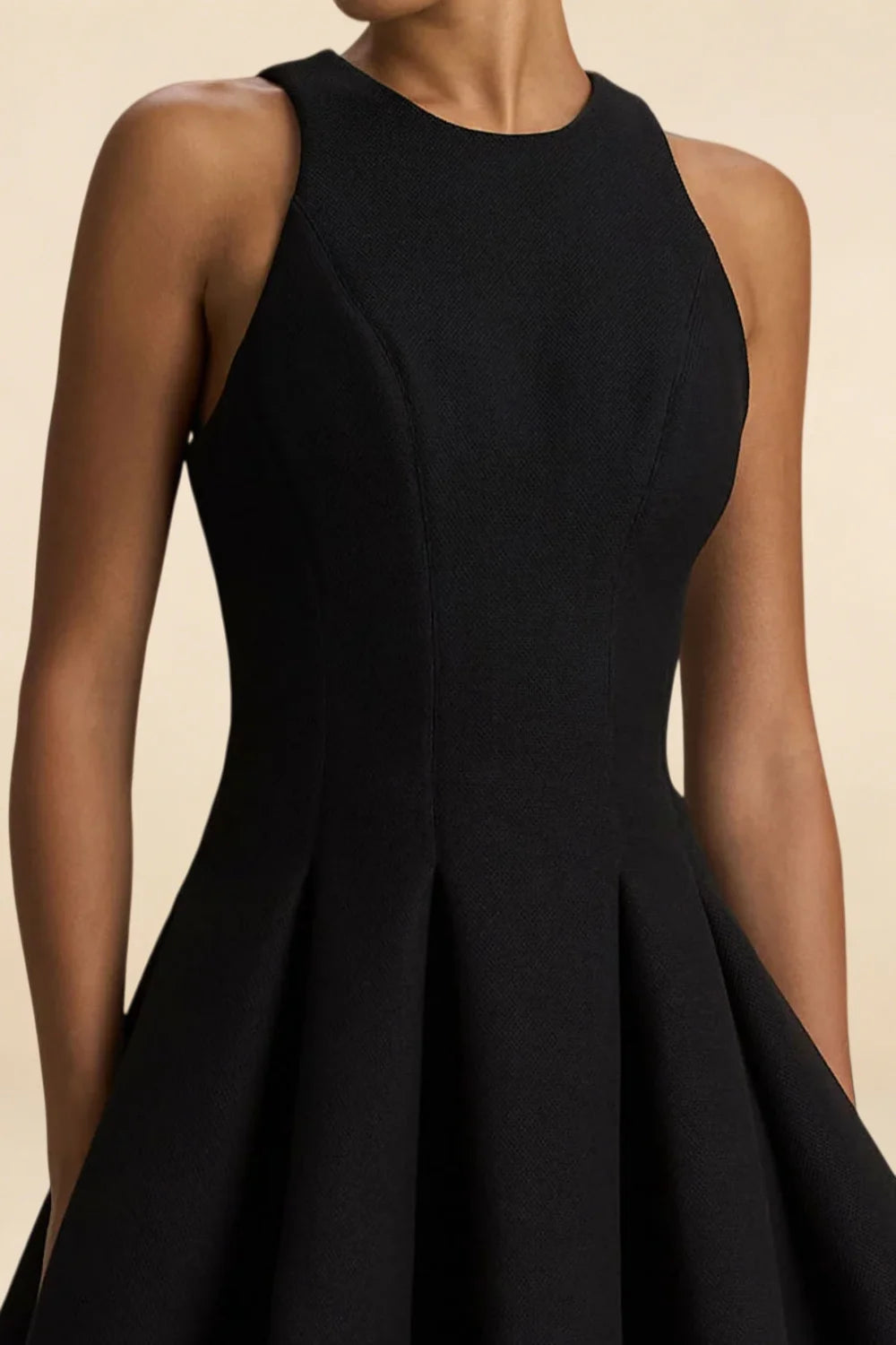 Textured crepe fabric detail of Cheryl black dress, high round neck design, sleeveless mini length for a sophisticated look