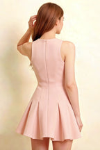 Detailed back view of Cheryl blush round neck dress, highlighting vertical seams and flared hem, sleeveless skater mini dress designed for homecoming dance