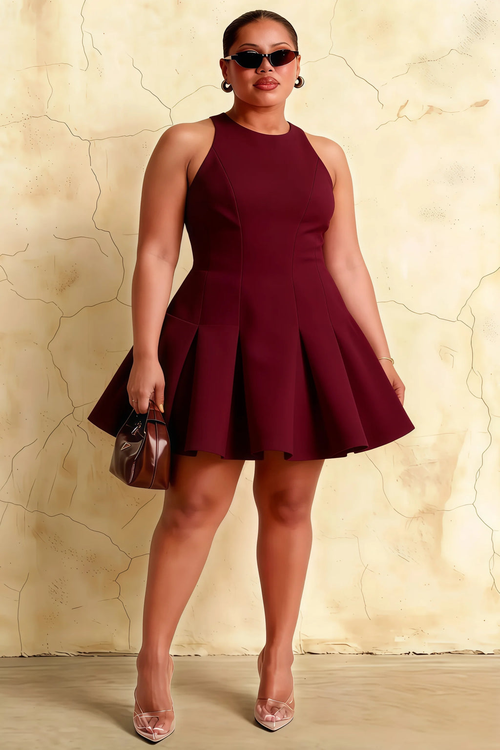 Curve model in burgundy Cheryl skater dress, plus size fit, holding clutch bag, suitable for evening party or semi-formal gathering.