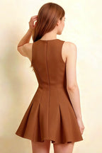 Back view brown Cheryl dress coffee crepe round neck sleeveless skater mini dress, model touching hair with elegant posture