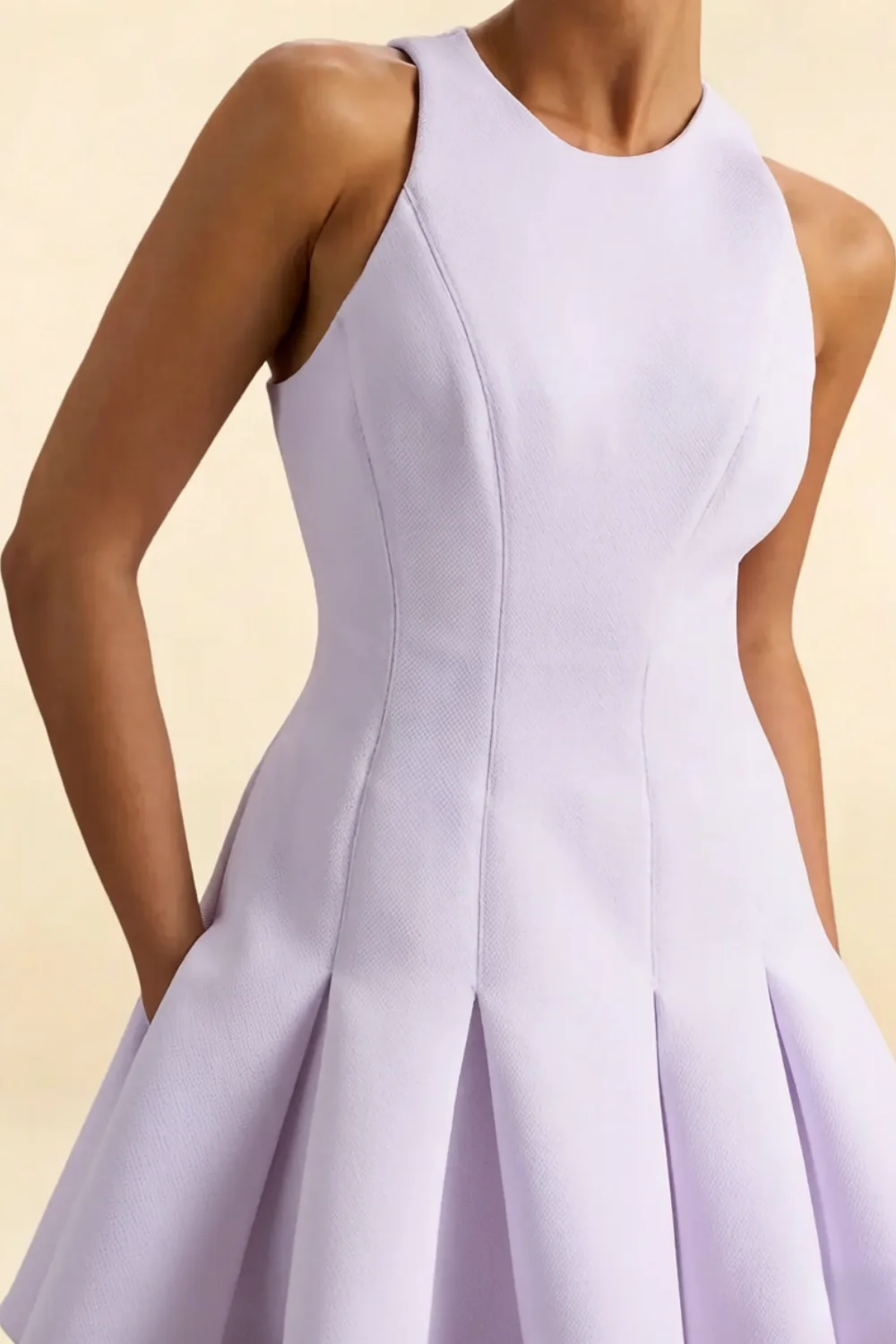 Close - up of lavender Cheryl crepe dress, round neck sleeveless skater mini dress, crepe fabric texture, fitted bodice with princess seams, elegant detailing for semi - formal, prom, bridesmaid party.