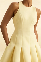 Detailed close-up of the Cheryl lemon dress bodice and round neckline, emphasizing the quality crepe material and structured waist seam.
