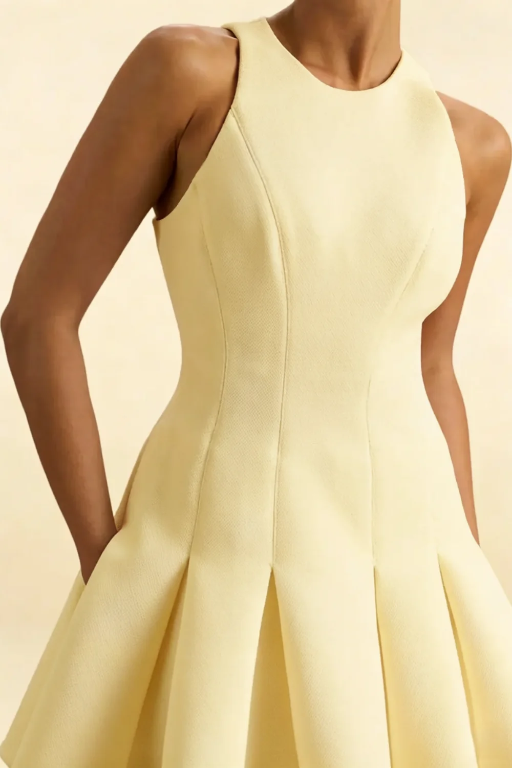 Detailed close-up of the Cheryl lemon dress bodice and round neckline, emphasizing the quality crepe material and structured waist seam.