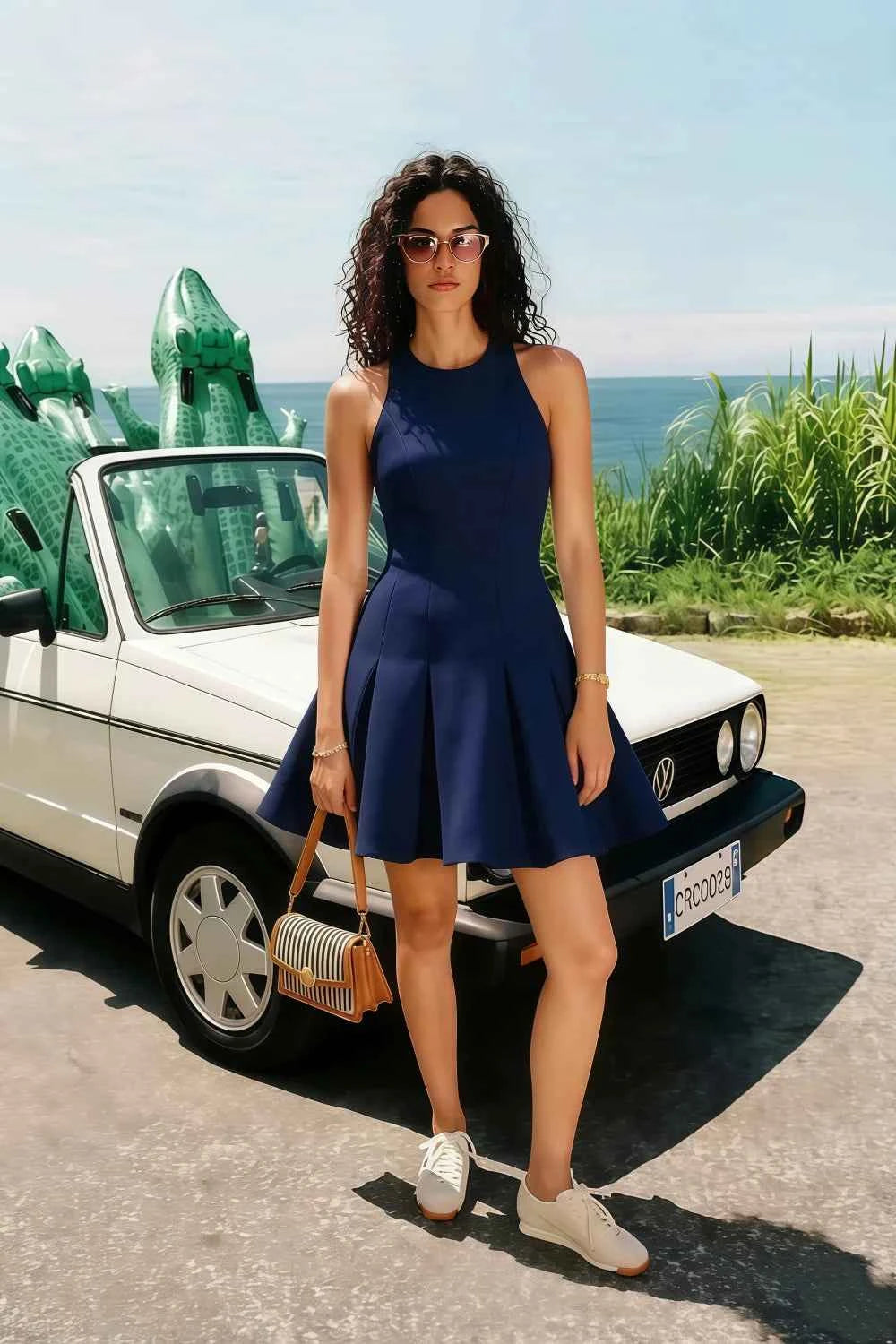 Real customer wearing the Cheryl crepe dress in navy for a summer vacation. Styled with sneakers for a casual, chic look by the beach or a daytime outing.