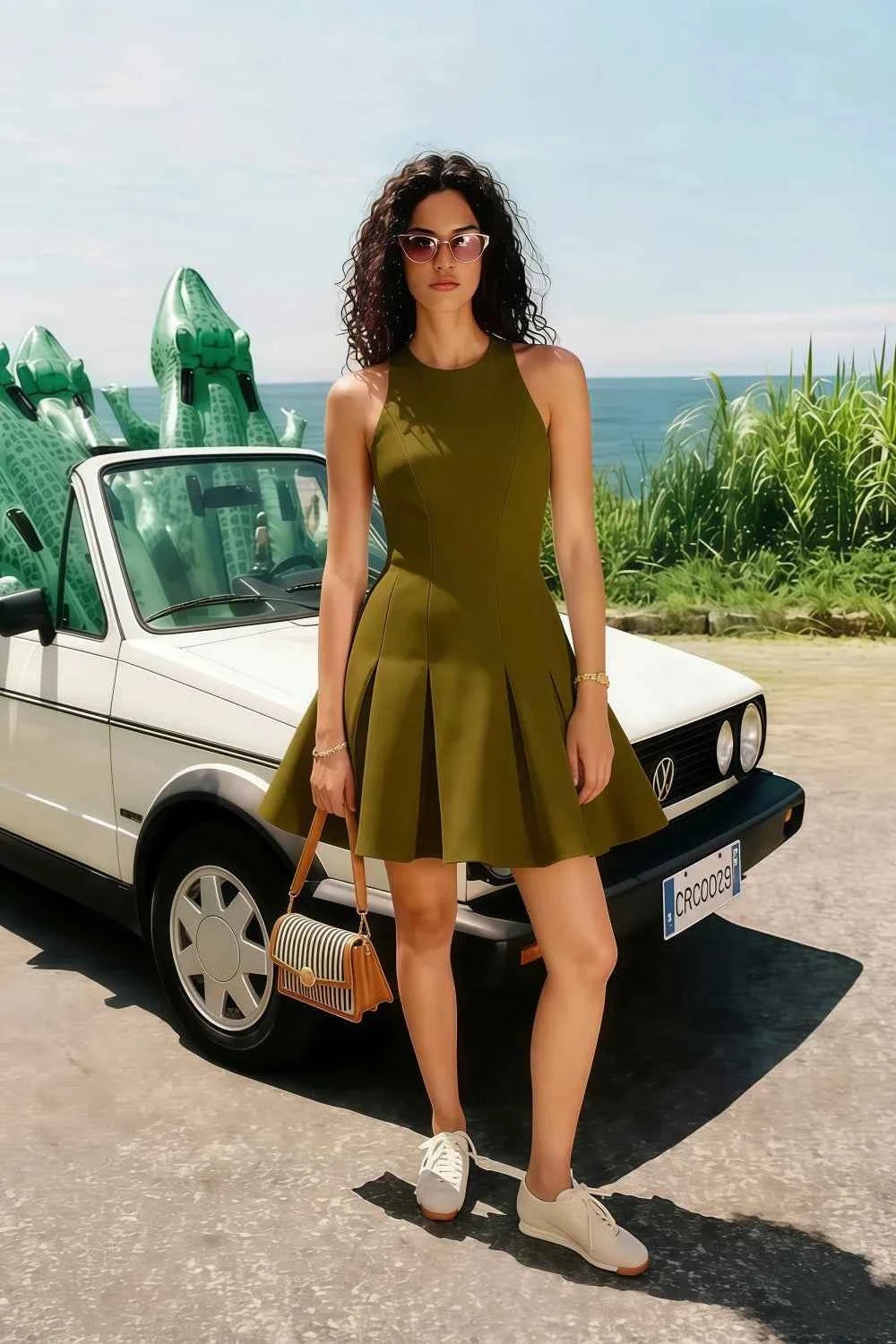 Real customer photo of the olive green Cheryl dress styled for a summer beach vacation, paired with white sneakers and a basket bag, radiating casual elegance.
