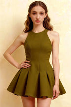 Studio portrait of a model in the olive round neck Cheryl dress highlighting the structured bodice and A-line silhouette, a versatile choice for cocktail parties.