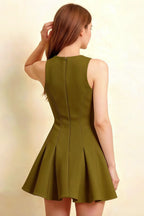 Rear view close-up of the sleeveless olive skater dress demonstrating the clean seam lines and flowy pleated hem, suitable for semi-formal occasions.