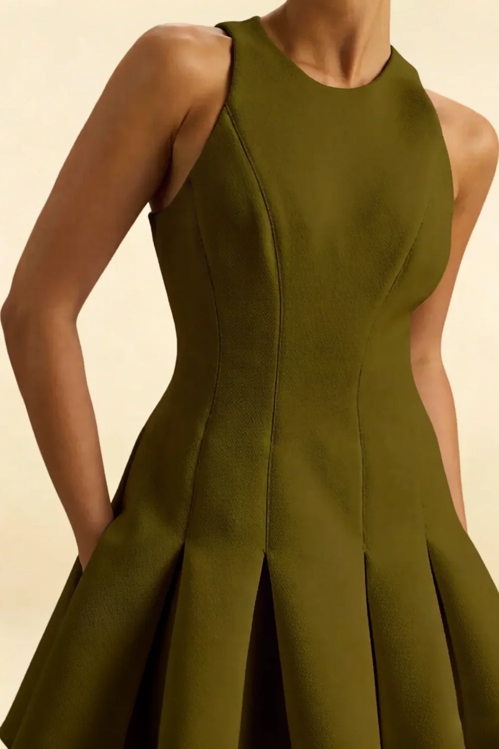 Close-up detail of the olive Cheryl dress highlighting the smooth crepe fabric texture and intricate seam construction on the bodice.
