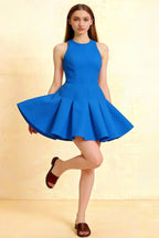Royal blue Cheryl dress round neck sleeveless skater mini dress in crepe fabric, perfect for homecoming or semi-formal events, front view with flared skirt and playful pose