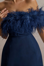 Close-up macro shot of the luxe dark navy feather trim and smooth crepe texture on the Chloe strapless cocktail dress.