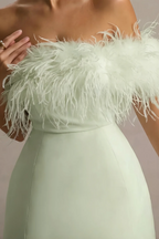 Close up of sage green crepe fabric and feather trim on Chloe strapless mini dress, luxury texture detail