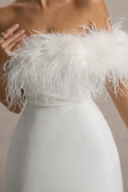Macro close-up of white feather trim on Chloe strapless mini dress, soft fluffy texture detail against skin, made with high-quality crepe fabric.