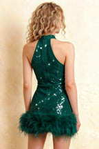 Rear view showcasing the open back zipper detail of Christine emerald sequin mini dress, model against neutral wall, highlighting feather trim for party or evening wear.