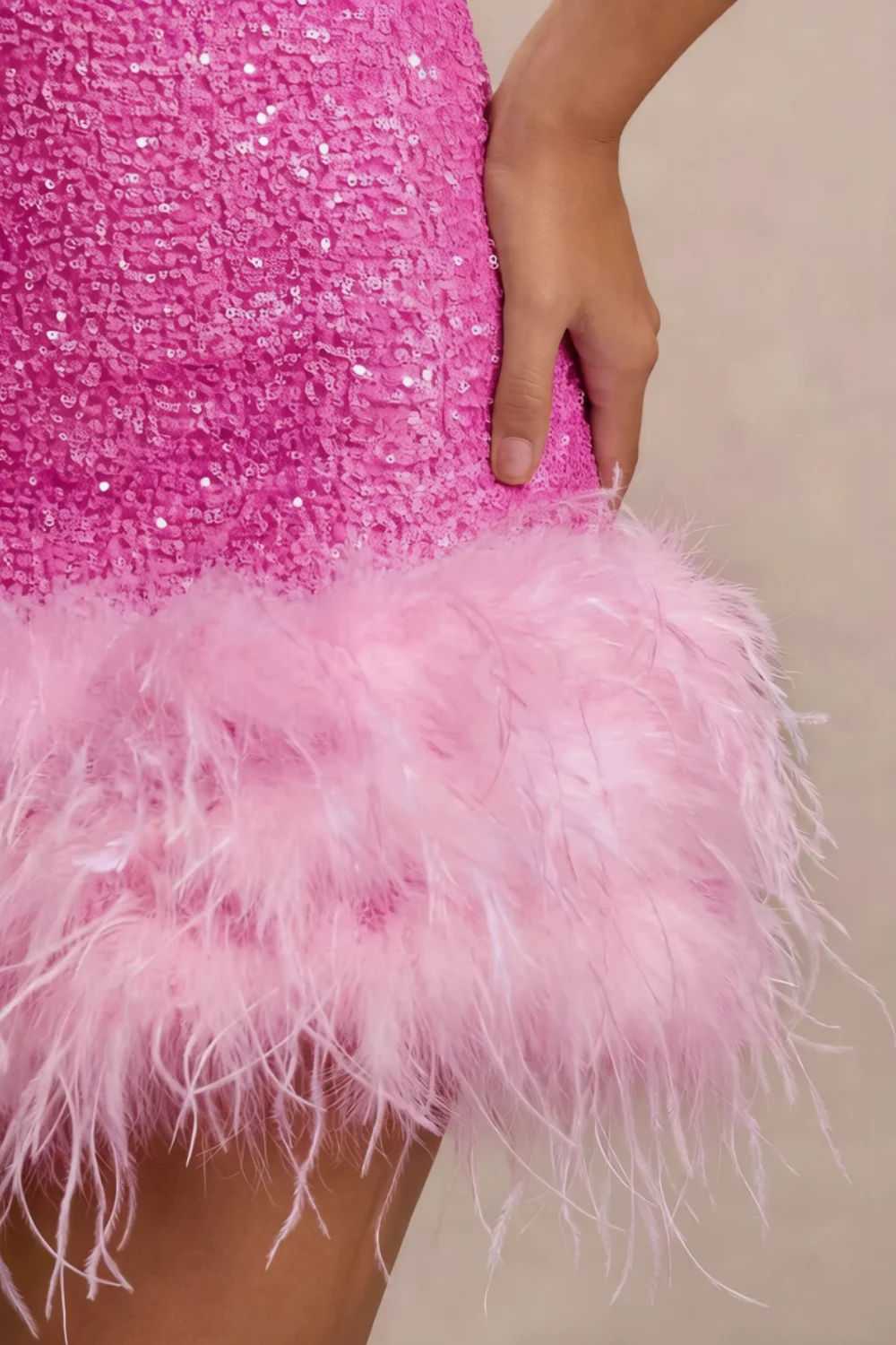 Macro detail of Christine dress feather trim and fuchsia sequin fabric texture, close up of sleeve less design