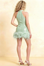 Back view of Christine mint green sequin cocktail dress with feather hem, high neck halter style, perfect for prom.