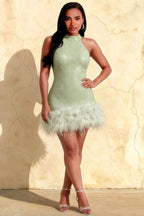 Plus size model wearing Christine mint green sequin high neck mini dress with feather hem, front view for inclusive fashion.