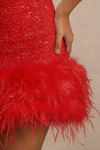 Christine red sequin dress feather trim close-up, detailed texture of feather hem and sequin fabric, luxury design element