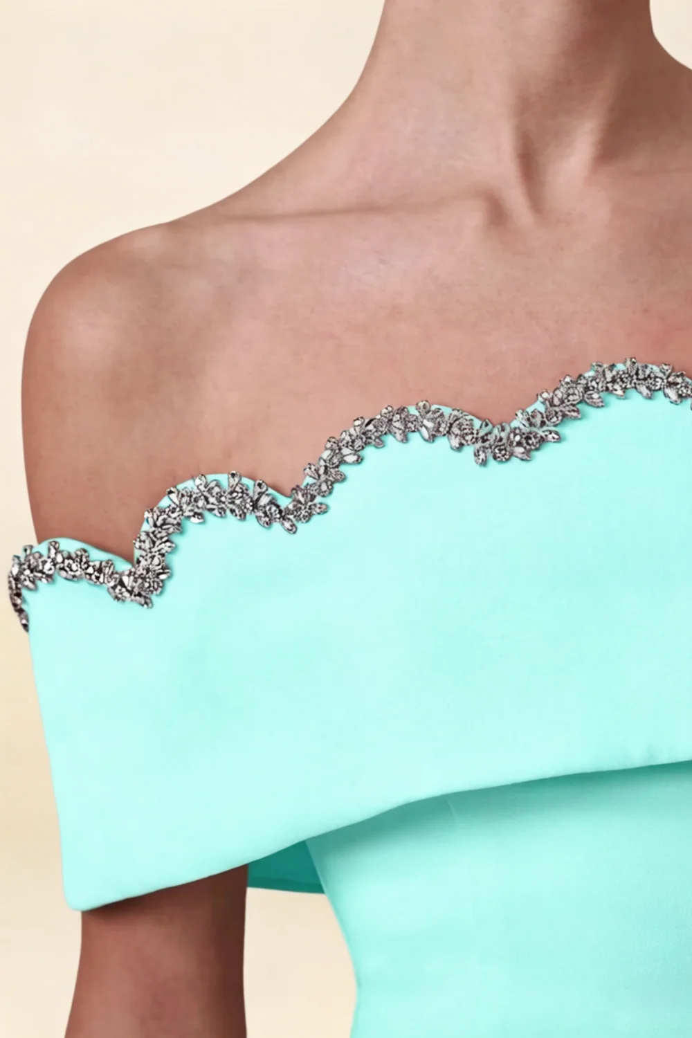 Macro close-up of the Christy aqua dress neckline, focusing on the intricate silver rhinestone wave trim detail.