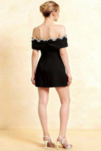 Back view of the Christy black crepe dress featuring a delicate sweetheart neckline and crystal embellishments.