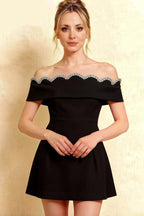 Close up of the Christy black cocktail dress highlighting the scalloped lace trim and sparkling rhinestone details.