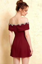 Detailed back view of Christy Burgundy dress highlighting the bow tie closure and elegant off-shoulder sleeve design.