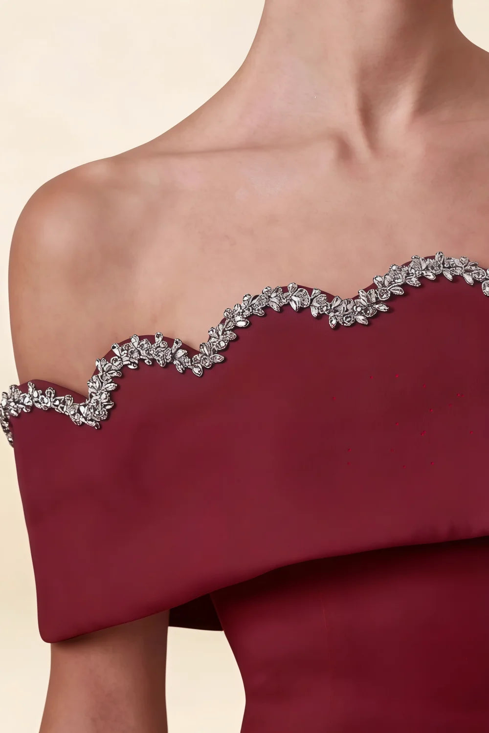 Macro close up of the rhinestone embellished scalloped edge on the Christy Burgundy off shoulder mini dress.