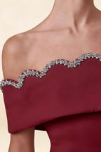 Macro close up of the rhinestone embellished scalloped edge on the Christy Burgundy off shoulder mini dress.