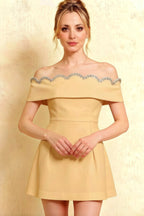 Studio portrait of elegant yellow Christy crepe dress, detailed silver rhinestone scallop neckline, short sleeves, feminine fit.