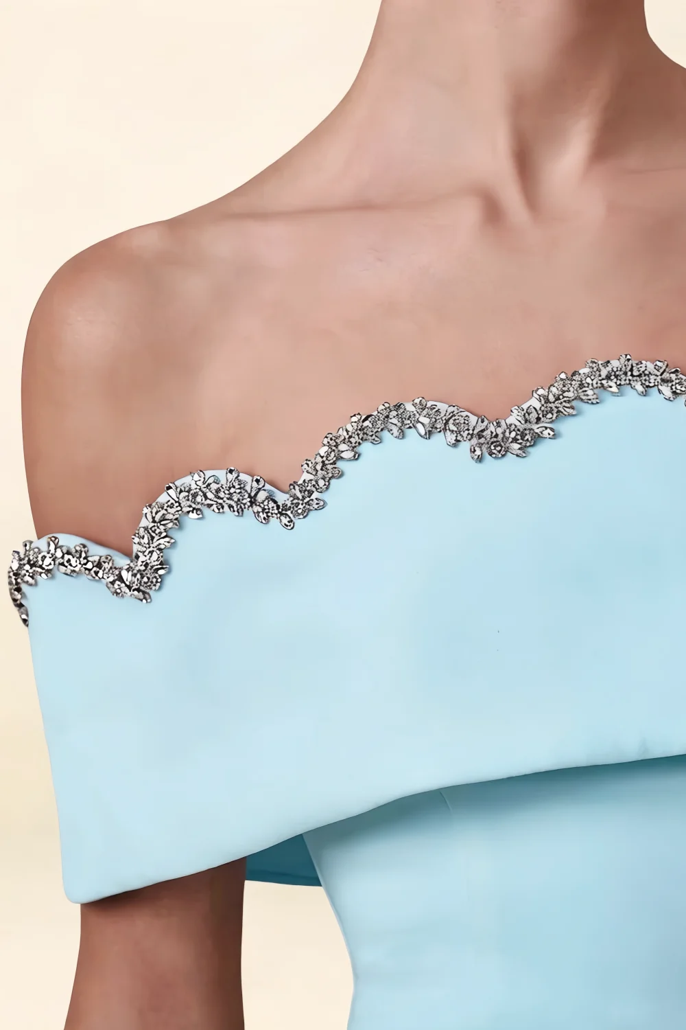 Extreme close-up of the rhinestone embellished scalloped neckline on the Christy light blue off the shoulder mini dress.