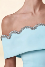 Extreme close-up of the rhinestone embellished scalloped neckline on the Christy light blue off the shoulder mini dress.