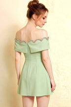 Side profile of Christy mint crepe prom dress showing the structured off-shoulder sleeves and flattering ruched waist detail.