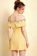 Side angle back view of the Christy yellow off shoulder dress highlighting the elegant bow detail at the back.