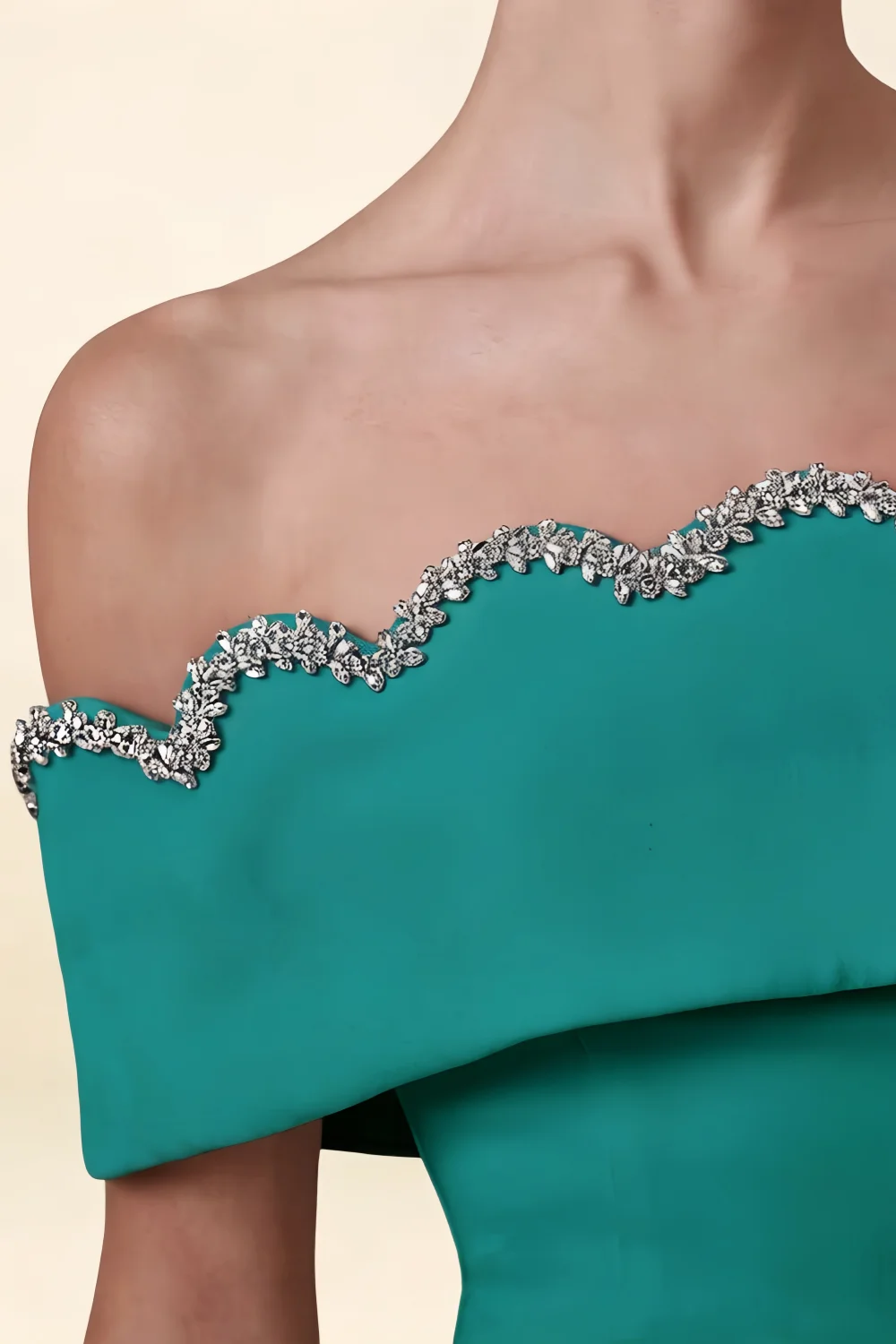 Close-Up of Christy Peacock Off-the-Shoulder Rhinestone Mini Dress – Luxurious rhinestone scalloped neckline on rich peacock crepe fabric. Perfect for bridesmaid parties or semi-formal soirées.