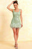 Front view of model in Cindy mint sequin bodycon square neck mini dress with feather trim, perfect for homecoming or cocktail parties.