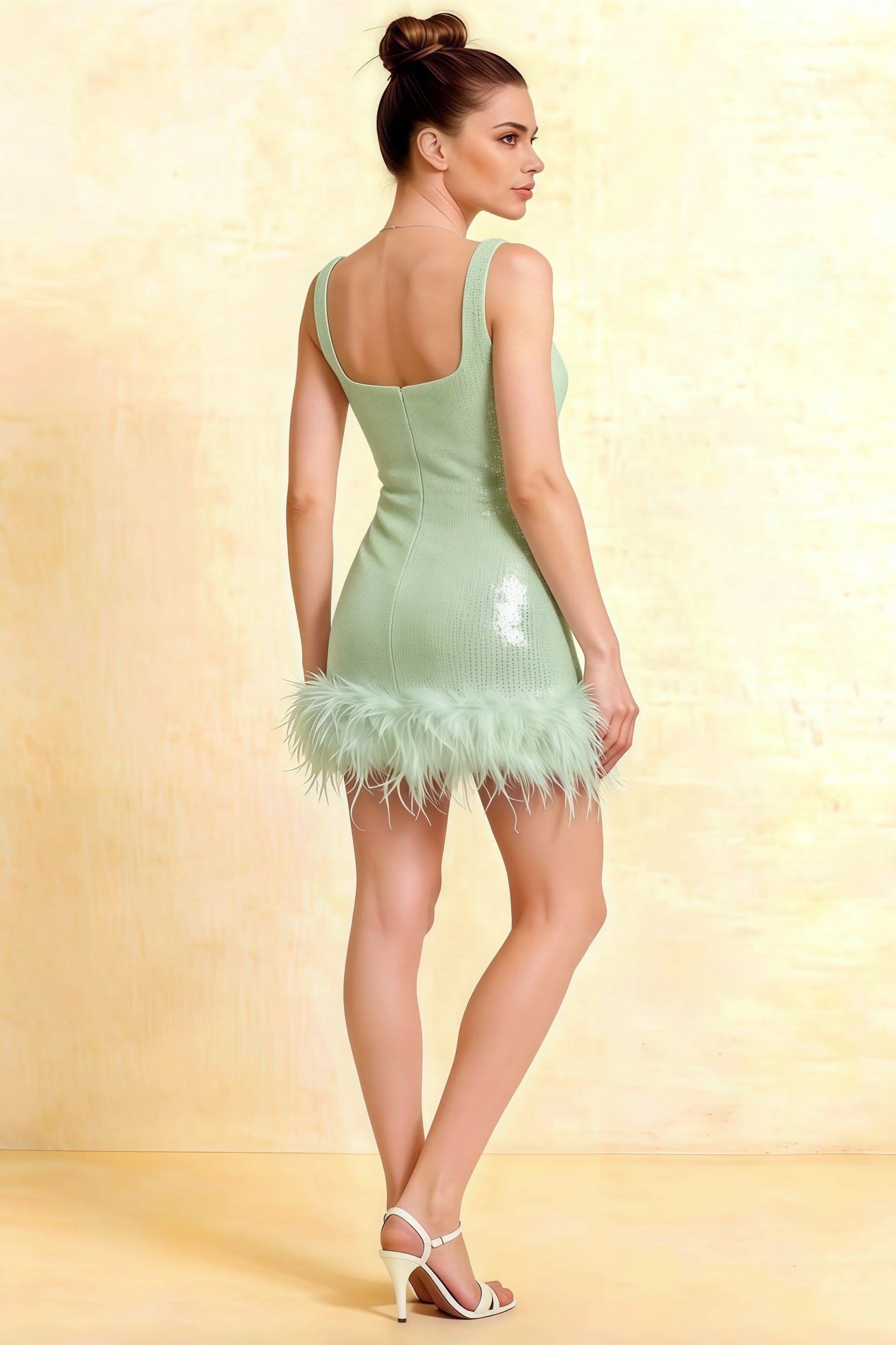 Back view of the Cindy mint green sequin dress featuring a flattering square neckline and feathered hem, ideal for semi-formal events.