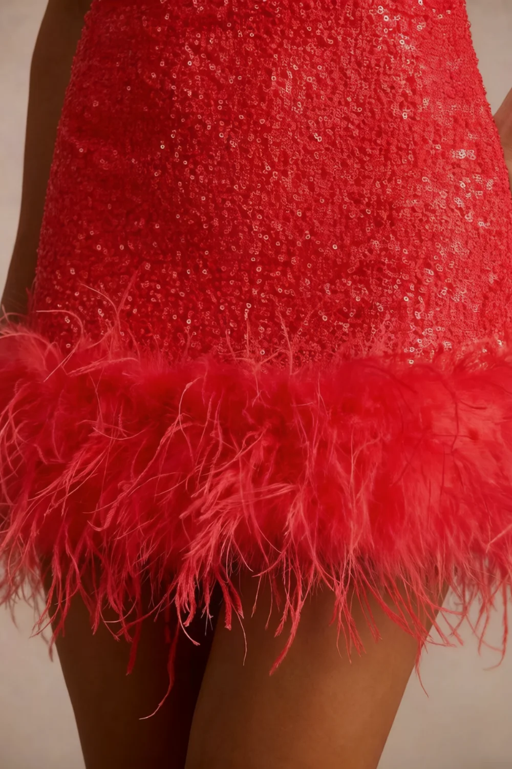 Close up macro shot of Cindy red sequin fabric texture and fluffy feather trim detailing