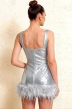 Rear view of plus size silver bodycon mini dress with square neckline and feather detailing.