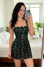 Customer photo of the Claire dark green lace dress, showcasing the fit and floral lace pattern in a real-life home setting.