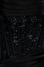 Extreme close-up detail of Clara dress bodice showcasing floral sequin lace applique over satin background fabric.