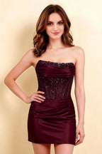 Elegant front view of Clara burgundy strapless dress with pleated ruched detailing and embellished bust