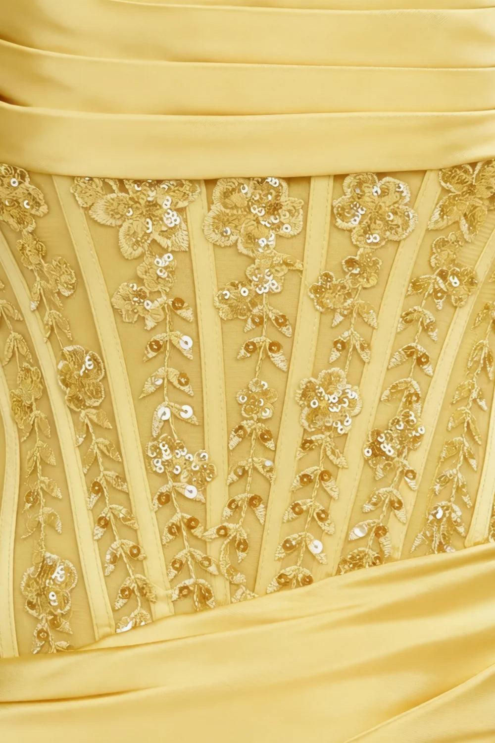 Close up of Clara lemon dress bodice intricate lace applique and sequin embellishment