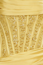 Close up of Clara lemon dress bodice intricate lace applique and sequin embellishment