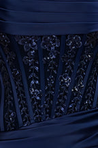 Close-up of Clara navy satin bodycon strapless mini dress bodice, showcasing intricate lace & sequin floral embroidery, vertical satin pleats, and smooth navy satin fabric details