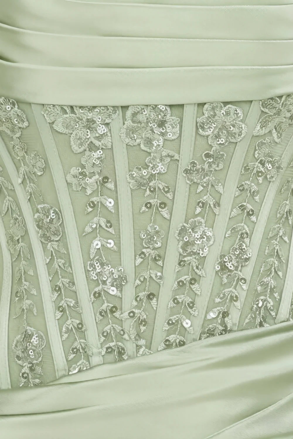 Close up of Clara dress bodice with intricate lace and sequin embellishment on sage green satin