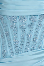 Macro close-up of Clara dress sky blue fabric with floral sequin lace and satin texture